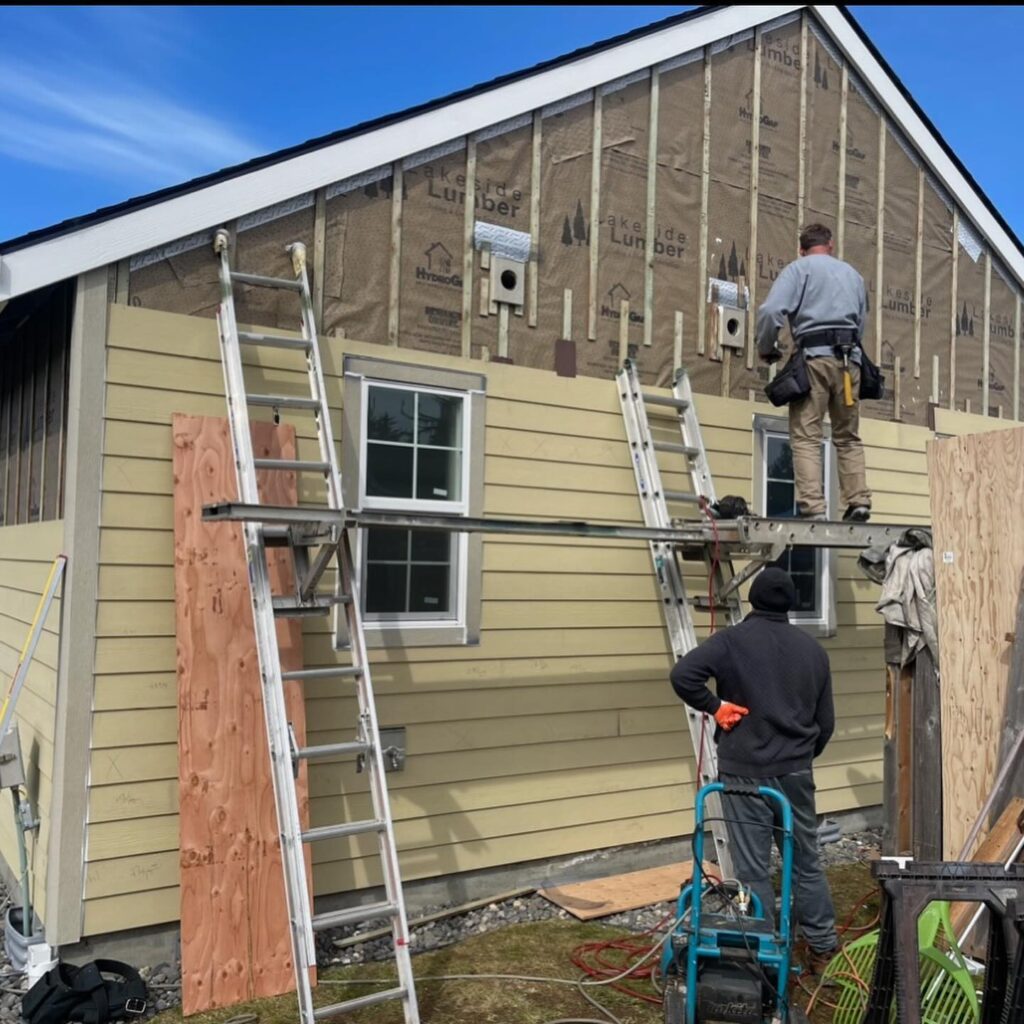 LADA Exteriors installing new siding on a home